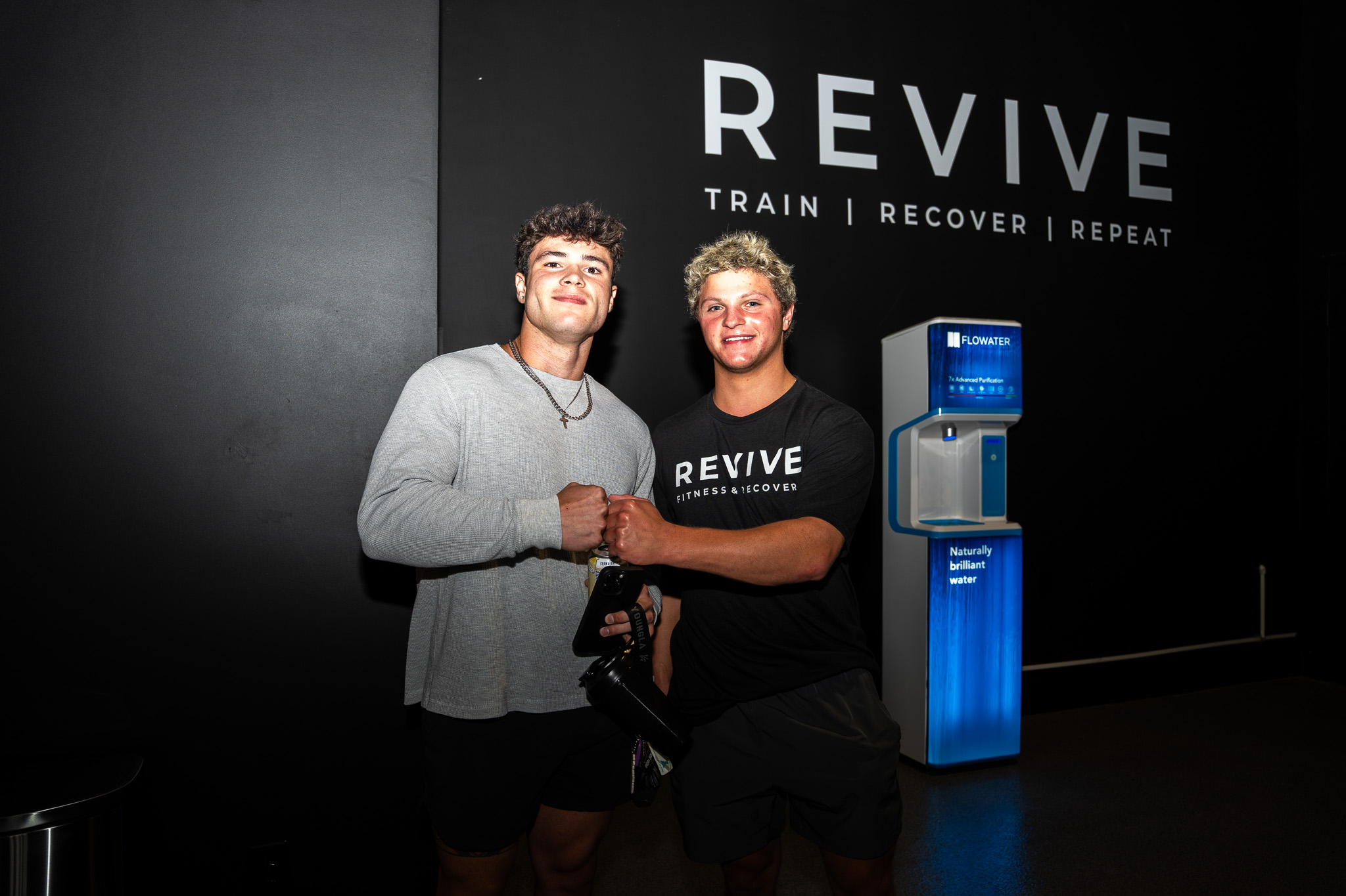 A fist bump at the REVIVE grand opening
